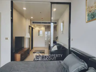 Modern studio apartment with sleek design and cozy living area, featuring a stylish bedroom and open living space.