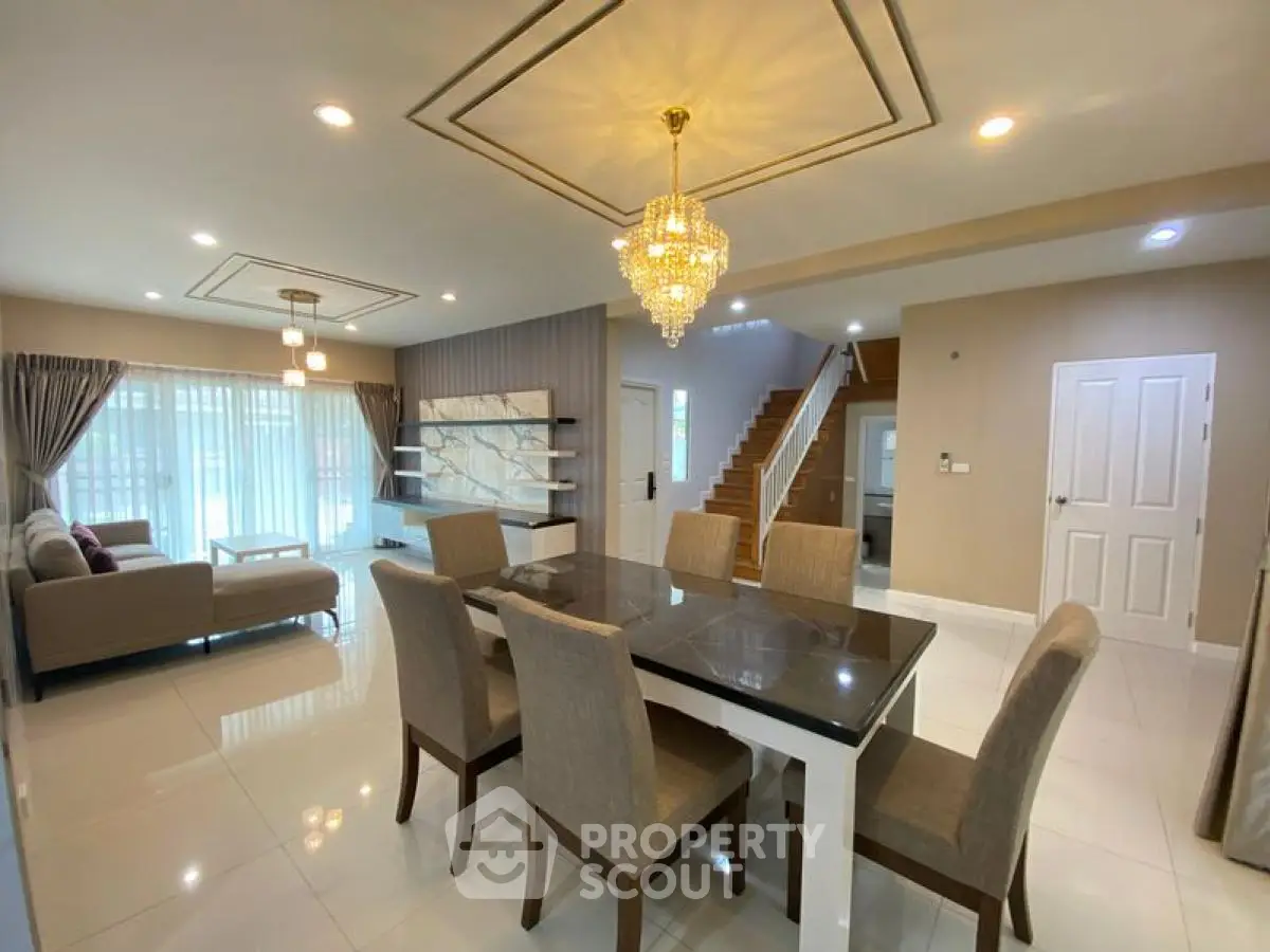 Elegant dining area with chandelier and modern decor in spacious living room