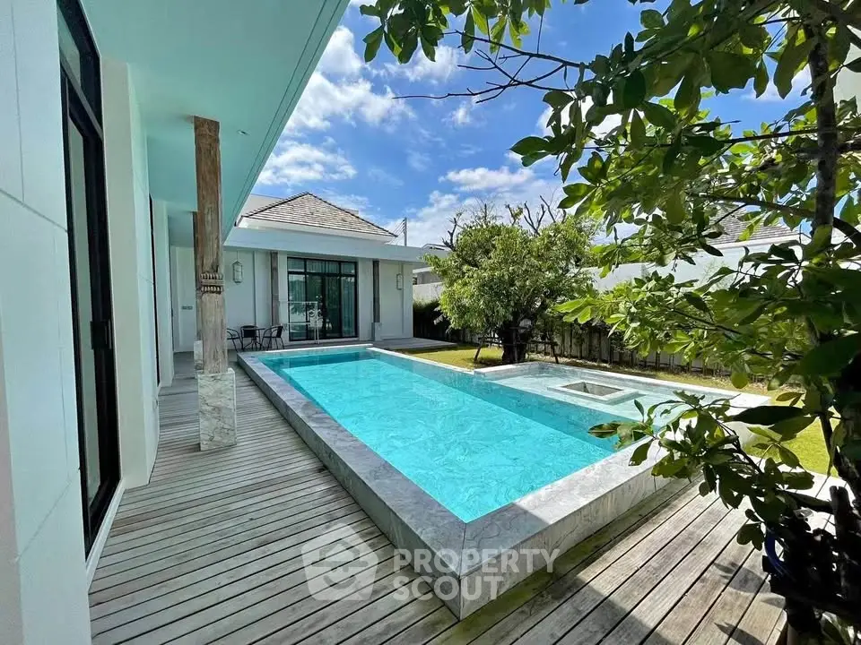 Luxurious modern villa with private pool and spacious deck area.