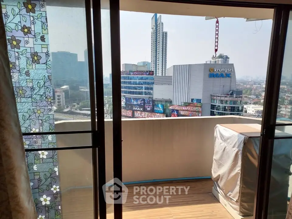 Spacious balcony with city view in modern high-rise apartment