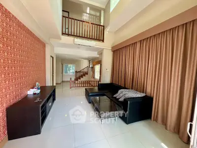 Spacious living room with high ceiling and modern decor in a stylish home