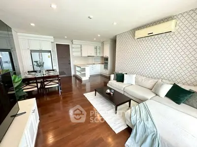 Spacious living room with elegant decor and open kitchen layout in modern apartment.