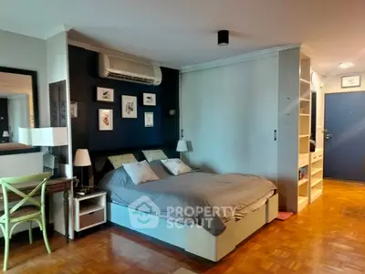 Cozy bedroom with stylish decor and parquet flooring in modern apartment