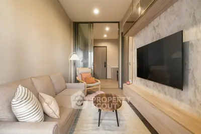 Modern living room with cozy sofa, stylish decor, and large flat-screen TV, perfect for relaxation and entertainment.