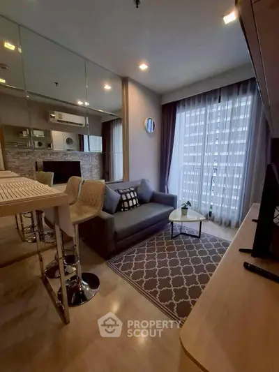 Modern living room with stylish decor and large window for natural light