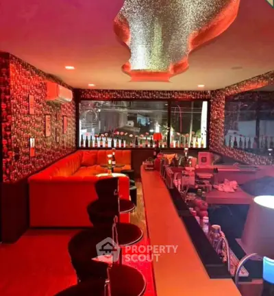 Luxurious home bar with stylish seating and ambient lighting, perfect for entertaining guests.