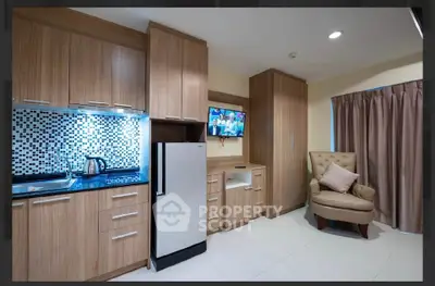Modern kitchen with sleek cabinetry and cozy seating area, perfect for urban living.