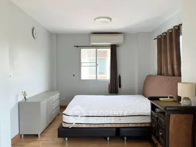 Spacious bedroom with modern decor and ample natural light