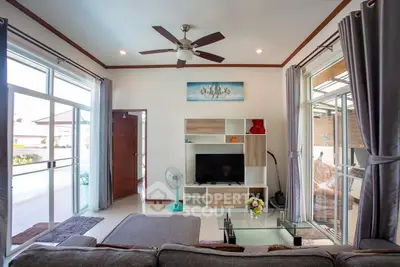 Spacious living room with modern decor and large windows for natural light.