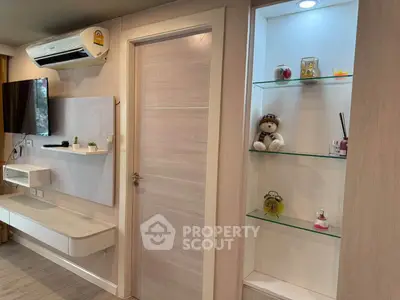 Modern living room with stylish shelving and wall-mounted TV
