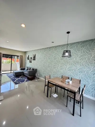 Spacious living room with modern decor and large windows offering natural light.