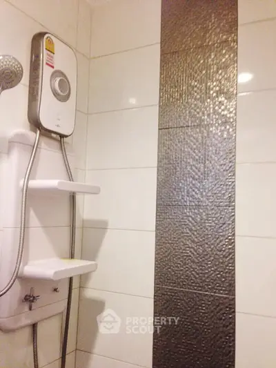 Modern bathroom with sleek shower and textured tile accent wall