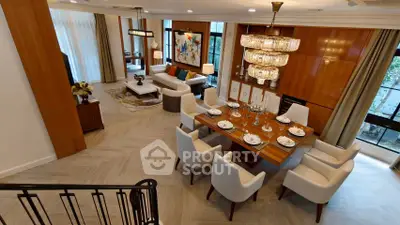 Luxurious open-plan living and dining area with elegant decor and chandelier lighting.