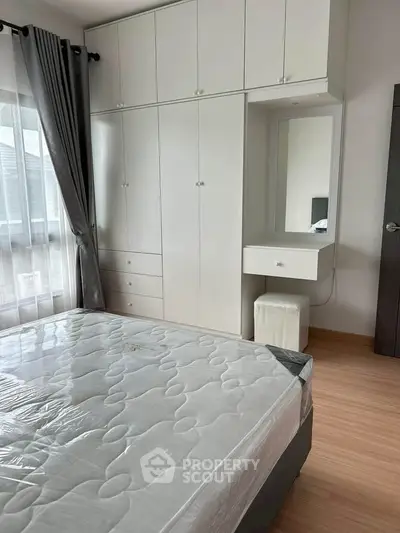 Modern bedroom with built-in wardrobe and natural light