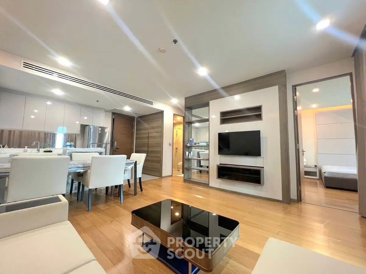 Modern open-plan living room with dining area and sleek kitchen design