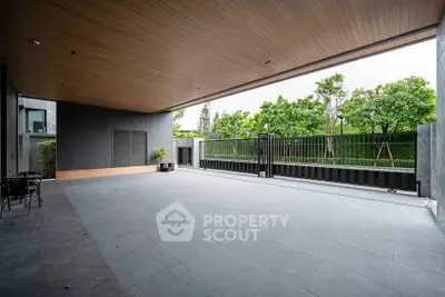 Spacious modern patio with sleek design and lush greenery view