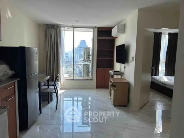 Modern apartment with open layout, city view, and sleek furnishings.