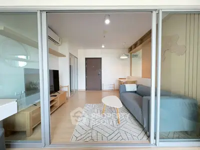 Modern living room with stylish furniture and large glass doors in a contemporary apartment.