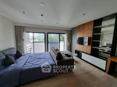 Spacious modern bedroom with balcony and city view, featuring elegant decor and ample natural light.