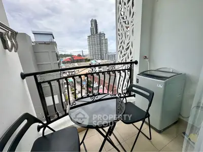 Charming balcony with city view, featuring modern chairs and washing machine, perfect for urban living.