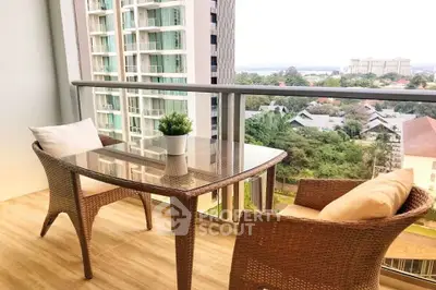 Spacious balcony with wicker furniture and stunning city view