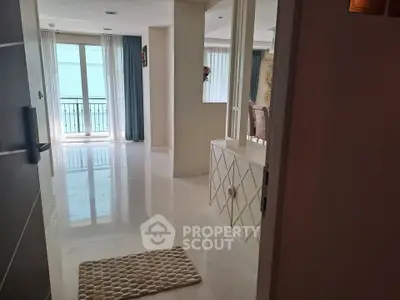 Spacious modern living room with elegant decor and large windows offering natural light.