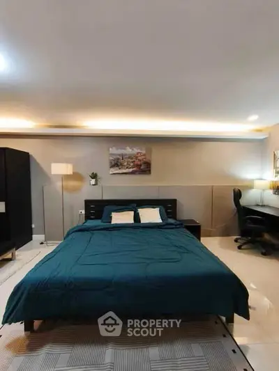 Spacious bedroom with modern decor and cozy lighting, perfect for relaxation and comfort.