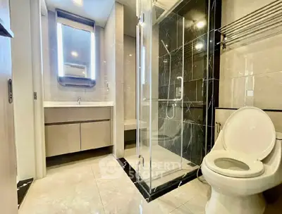 Luxurious modern bathroom with glass shower and elegant fixtures