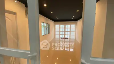 Spacious empty room with glossy flooring and large windows