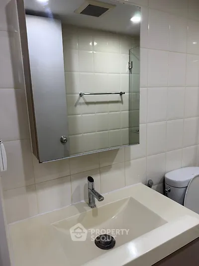 Modern bathroom with sleek sink and mirror cabinet