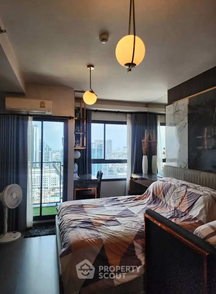 Modern bedroom with city view, stylish decor, and ample natural light.