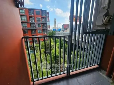 Modern balcony with city view and lush greenery, perfect for urban living.