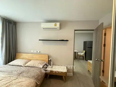 Modern bedroom with air conditioning and minimalist decor in a stylish apartment.