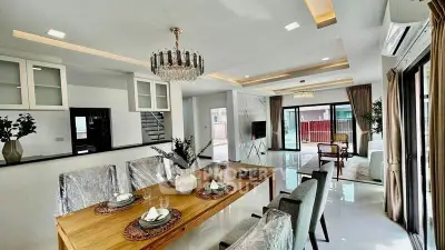 Luxurious open-plan living and dining area with elegant decor and ample natural light.