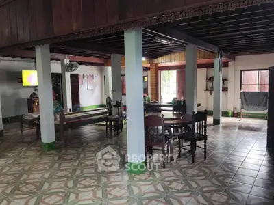 Spacious open-plan living area with traditional decor and tiled flooring
