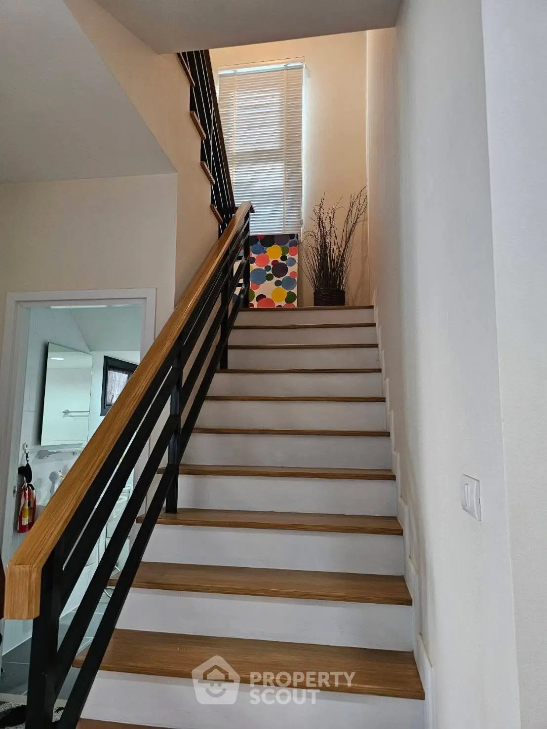 Modern staircase with sleek railing and natural light, perfect for contemporary homes.