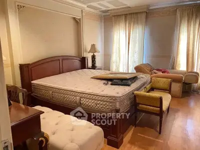 Spacious bedroom with elegant wooden furniture and natural light