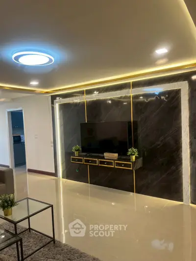 Luxurious modern living room with sleek TV wall and ambient lighting