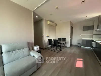 Modern open-plan living room with dining area and sleek kitchen design