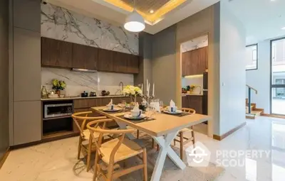 Luxurious modern kitchen with elegant dining area and marble accents