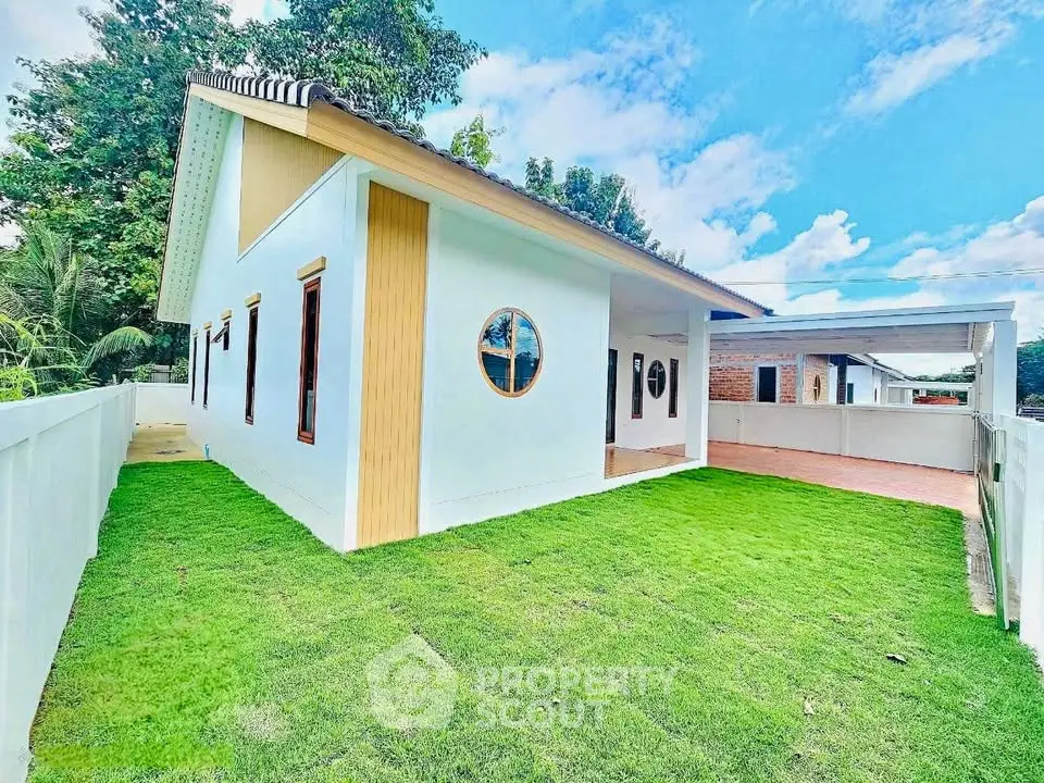 Modern single-story house with lush green lawn and unique circular windows.
