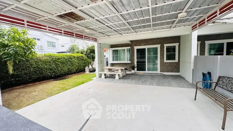 Spacious covered patio with garden view in modern residential property