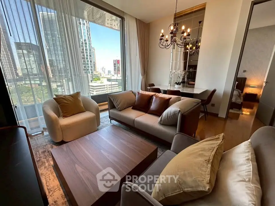 Luxurious living room with city view, elegant furniture, and modern chandelier in high-rise apartment.
