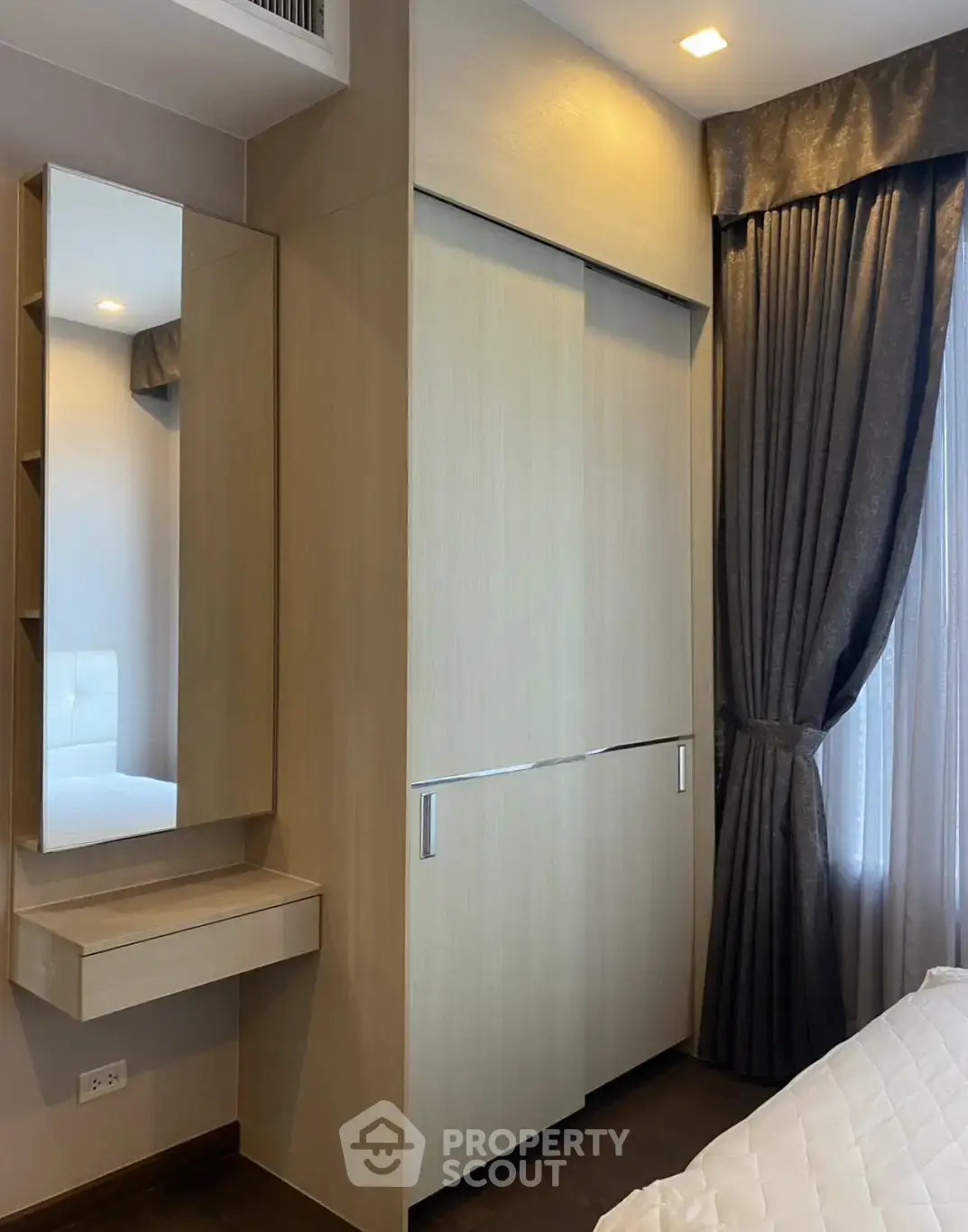 Modern bedroom with built-in wardrobe and elegant curtains