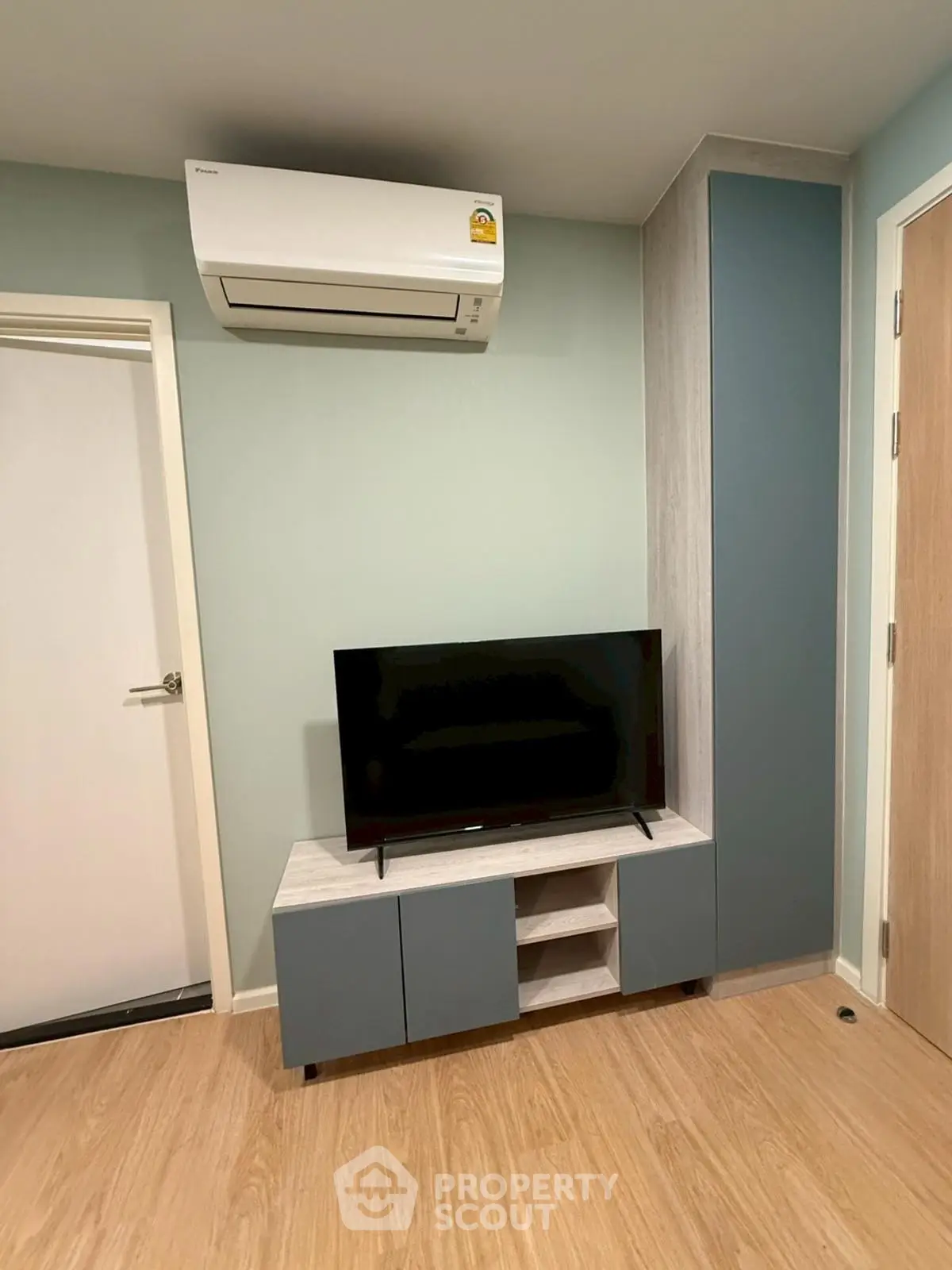 Modern living room with sleek TV unit and air conditioning