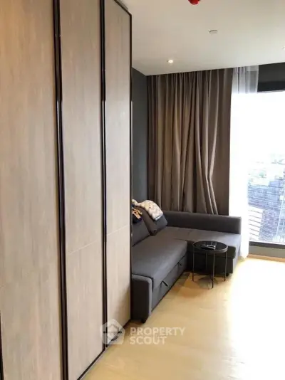Modern living room with sleek design and large windows offering natural light.
