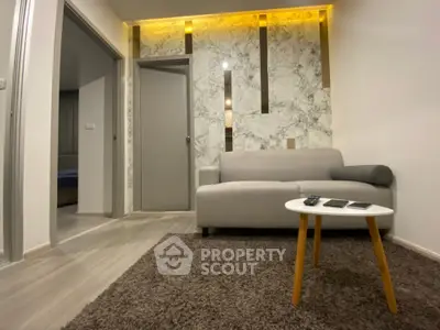 Modern living room with stylish marble accent wall and cozy sofa