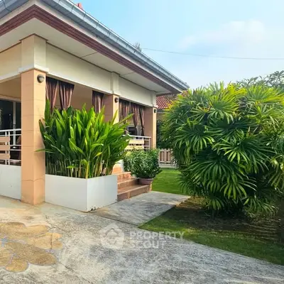 Charming single-story home with lush garden and inviting porch, perfect for serene living.