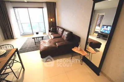 Modern living room with leather sectional sofa and large mirror, featuring a balcony view.