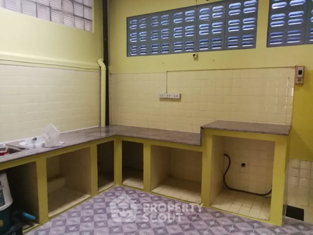 Spacious kitchen with open layout and tiled countertops, ready for customization.